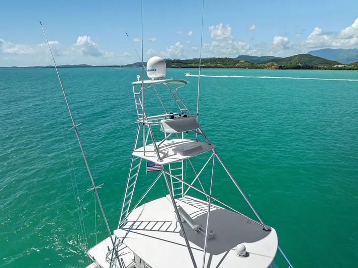 Ivelymar Yacht Photos Pics Viking 56 Convertible yacht, 2005 model, cruising in turquoise waters with scenic island backdrop.