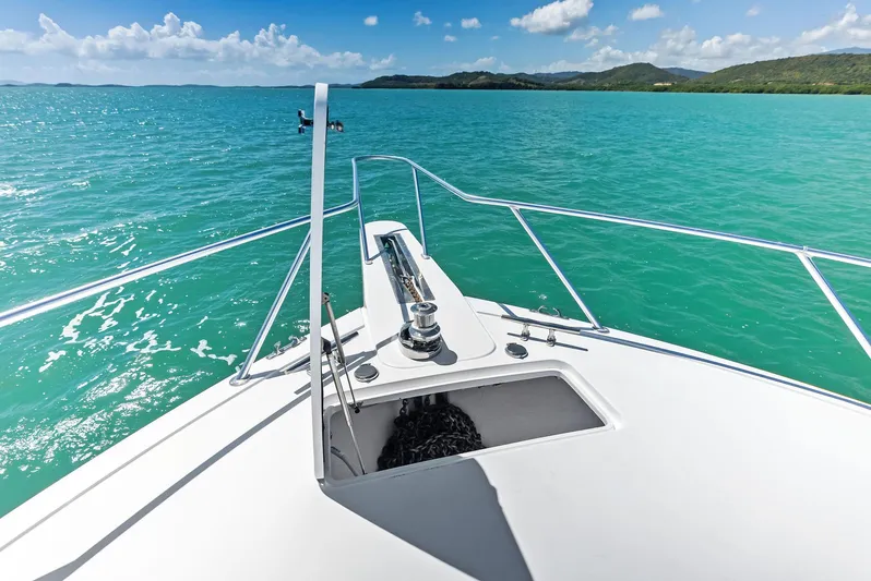 Ivelymar Yacht Photos Pics Bow view of 2005 Viking 56 Convertible yacht on turquoise waters under blue sky.