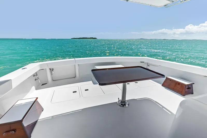 Ivelymar Yacht Photos Pics 2005 Viking 56 Convertible yacht deck with ocean view and table.