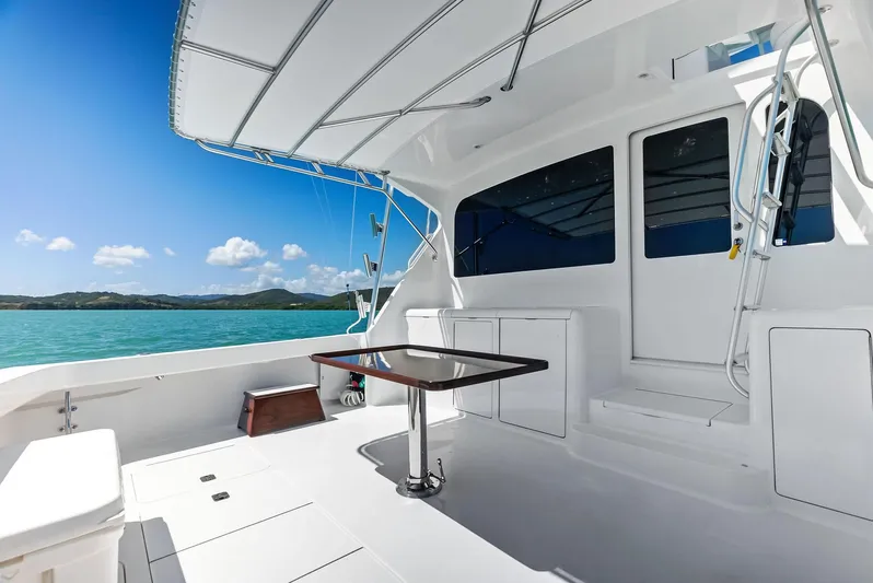 Ivelymar Yacht Photos Pics 2005 Viking 56 Convertible yacht deck with ocean view and clear blue sky.