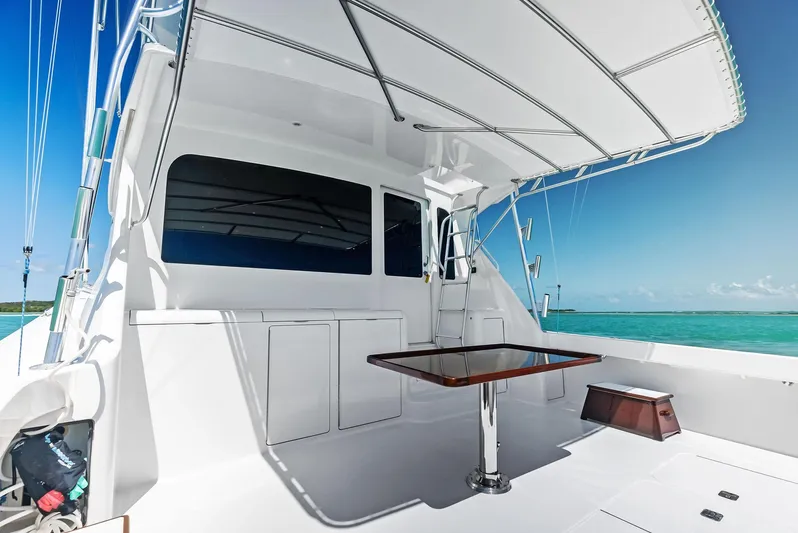 Ivelymar Yacht Photos Pics 2005 Viking 56 Convertible yacht deck with table, ocean view, and clear sky.