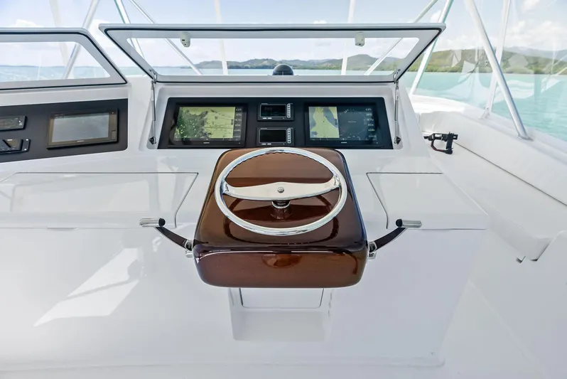 Ivelymar Yacht Photos Pics Steering console of 2005 Viking 56 Convertible yacht with modern navigation displays.