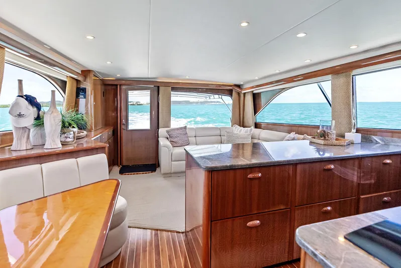 Ivelymar Yacht Photos Pics Luxurious interior of 2005 Viking 56 Convertible yacht with elegant wood finishes and ocean view.