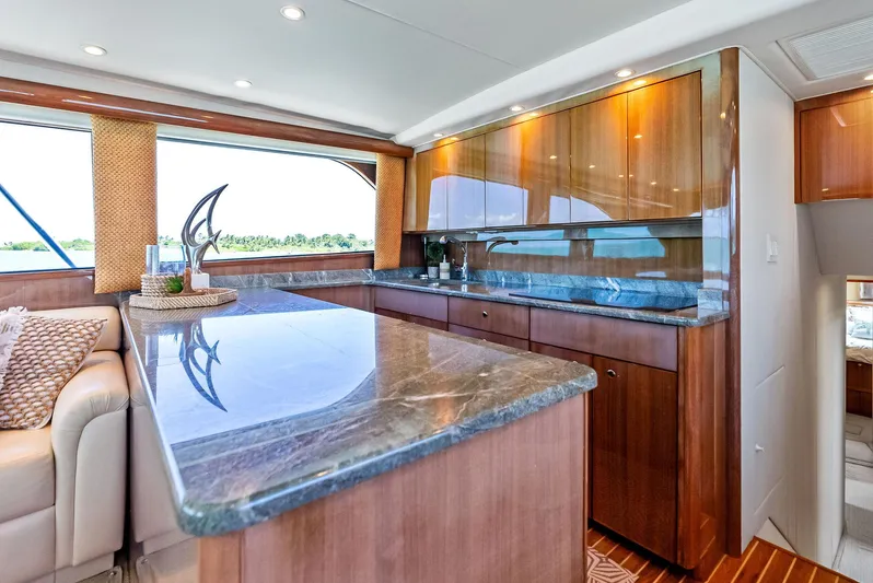 Ivelymar Yacht Photos Pics Luxurious kitchen interior of 2005 Viking 56 Convertible yacht with marble countertops.