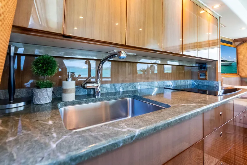 Ivelymar Yacht Photos Pics Luxurious kitchen interior of 2005 Viking 56 Convertible yacht with sleek countertops.