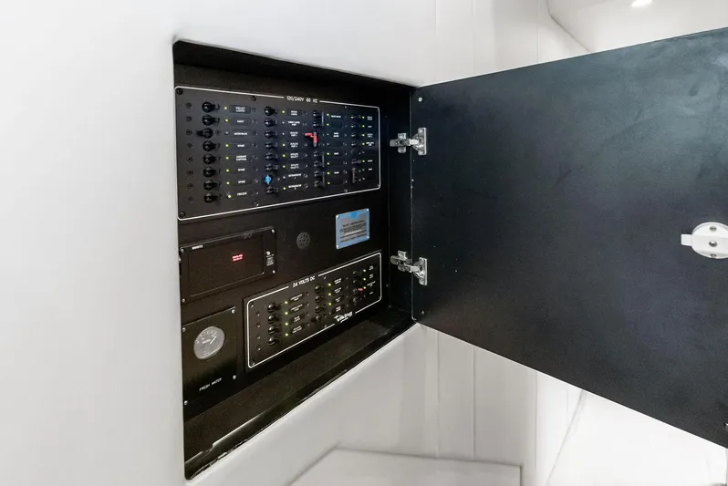 Ivelymar Yacht Photos Pics Electrical panel inside 2005 Viking 56 Convertible yacht, showcasing control switches and gauges.