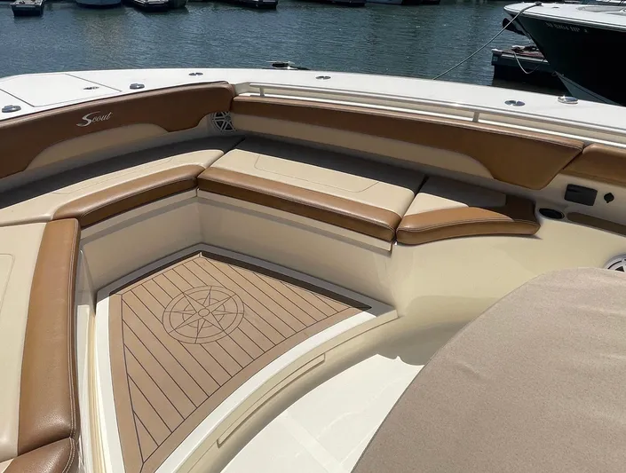 Shady Lady II Yacht Photos Pics 2019 Scout 380 LXF boat interior with tan seating and wood accents, docked by the water.