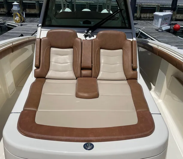 Shady Lady II Yacht Photos Pics Luxurious seating on a 2019 Scout 380 LXF boat, featuring brown and beige upholstery.