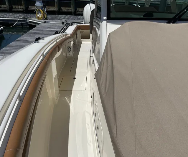 Shady Lady II Yacht Photos Pics 2019 Scout 380 LXF boat deck with beige cover, docked at marina.
