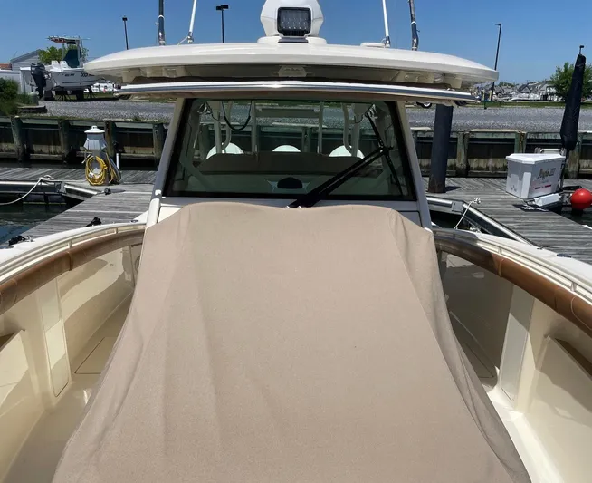 Shady Lady II Yacht Photos Pics 2019 Scout 380 LXF boat docked, covered with beige tarp, sunny day.
