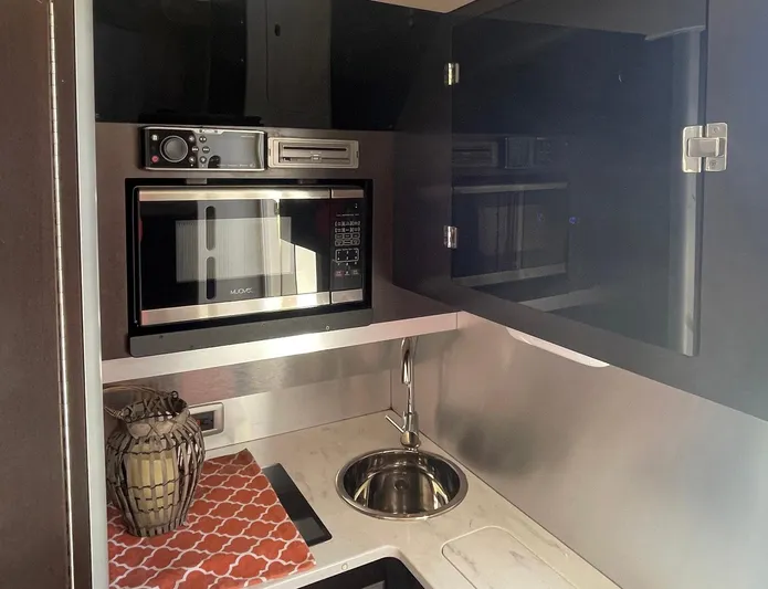 Shady Lady II Yacht Photos Pics Compact kitchen area in 2019 Scout 380 LXF boat with microwave and sink.