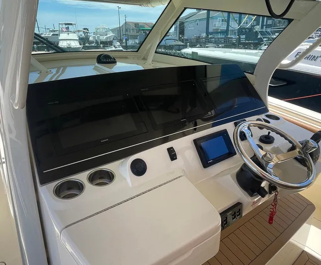 Shady Lady II Yacht Photos Pics 2019 Scout 380 LXF boat dashboard with steering wheel and navigation screens.