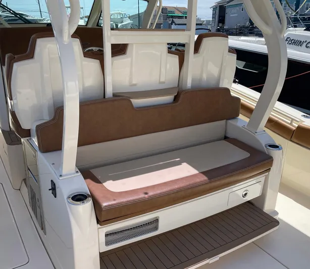 Shady Lady II Yacht Photos Pics 2019 Scout 380 LXF boat seating area with brown and white upholstery.