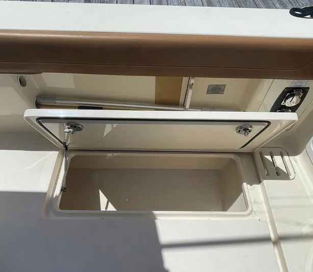 Shady Lady II Yacht Photos Pics 2019 Scout 380 LXF boat storage compartment with open lid, showcasing interior space.