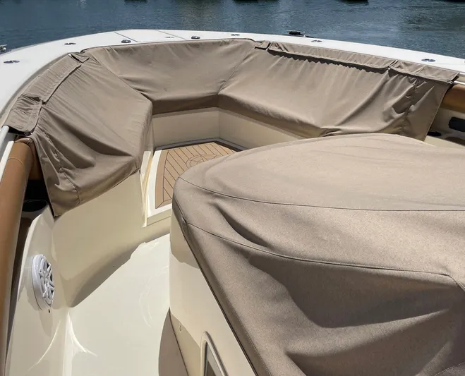 Shady Lady II Yacht Photos Pics 2019 Scout 380 LXF boat interior with beige covers and wooden deck.