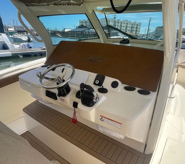 Shady Lady II Yacht Photos Pics 2019 Scout 380 LXF boat helm with steering wheel and controls, docked at marina.