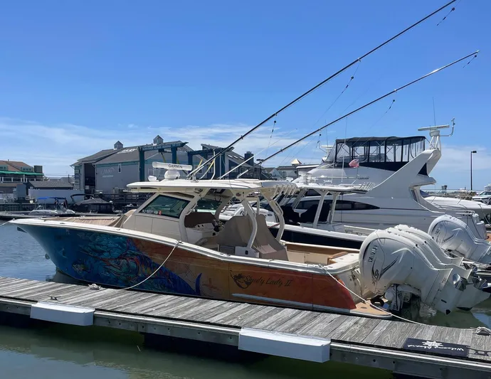 Shady Lady II Yacht Photos Pics 2019 Scout 380 LXF boat docked at marina with vibrant hull design.
