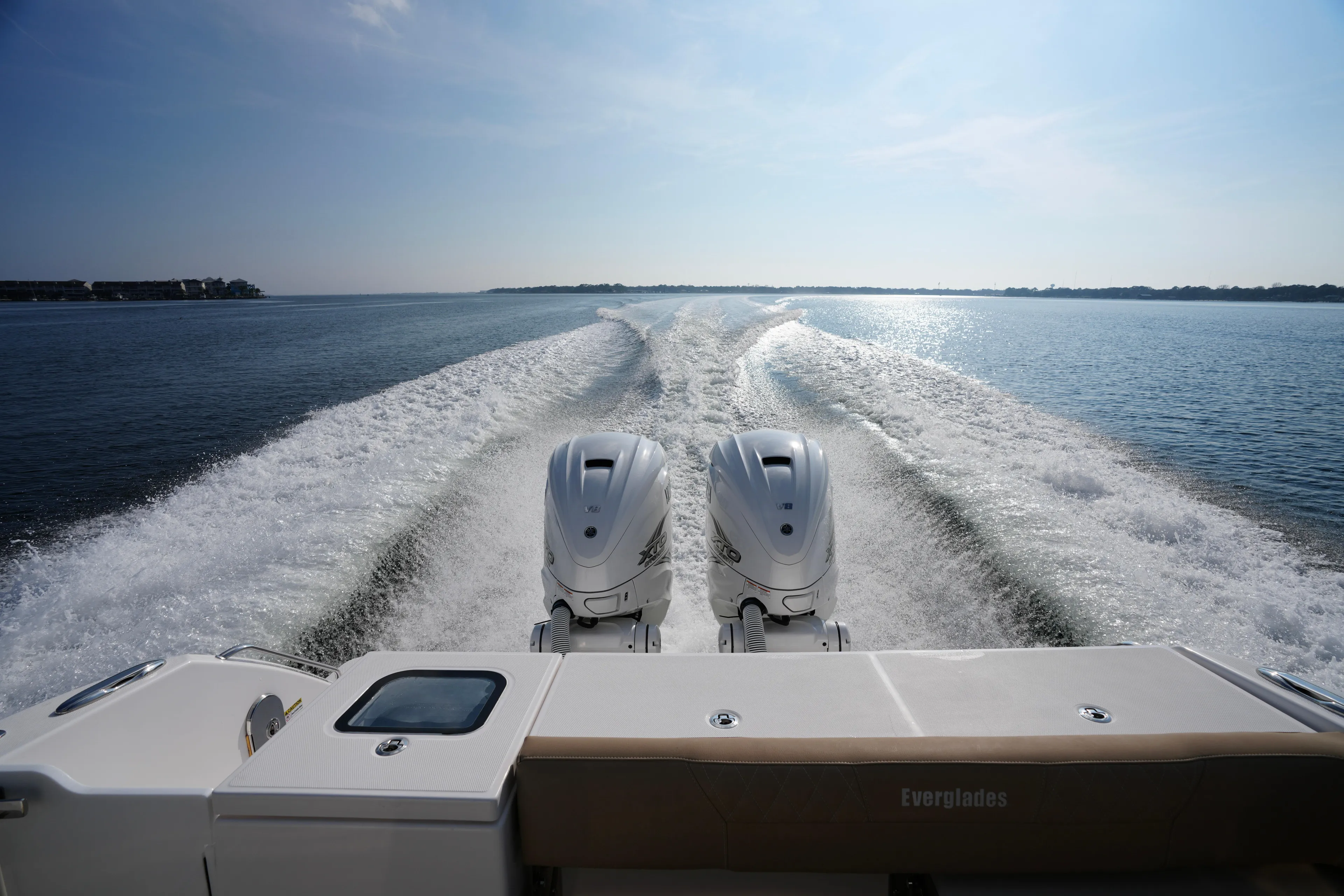  Yacht Photos Pics 2023 Everglades 340 Dual Console boat cruising on open water, twin engines visible.