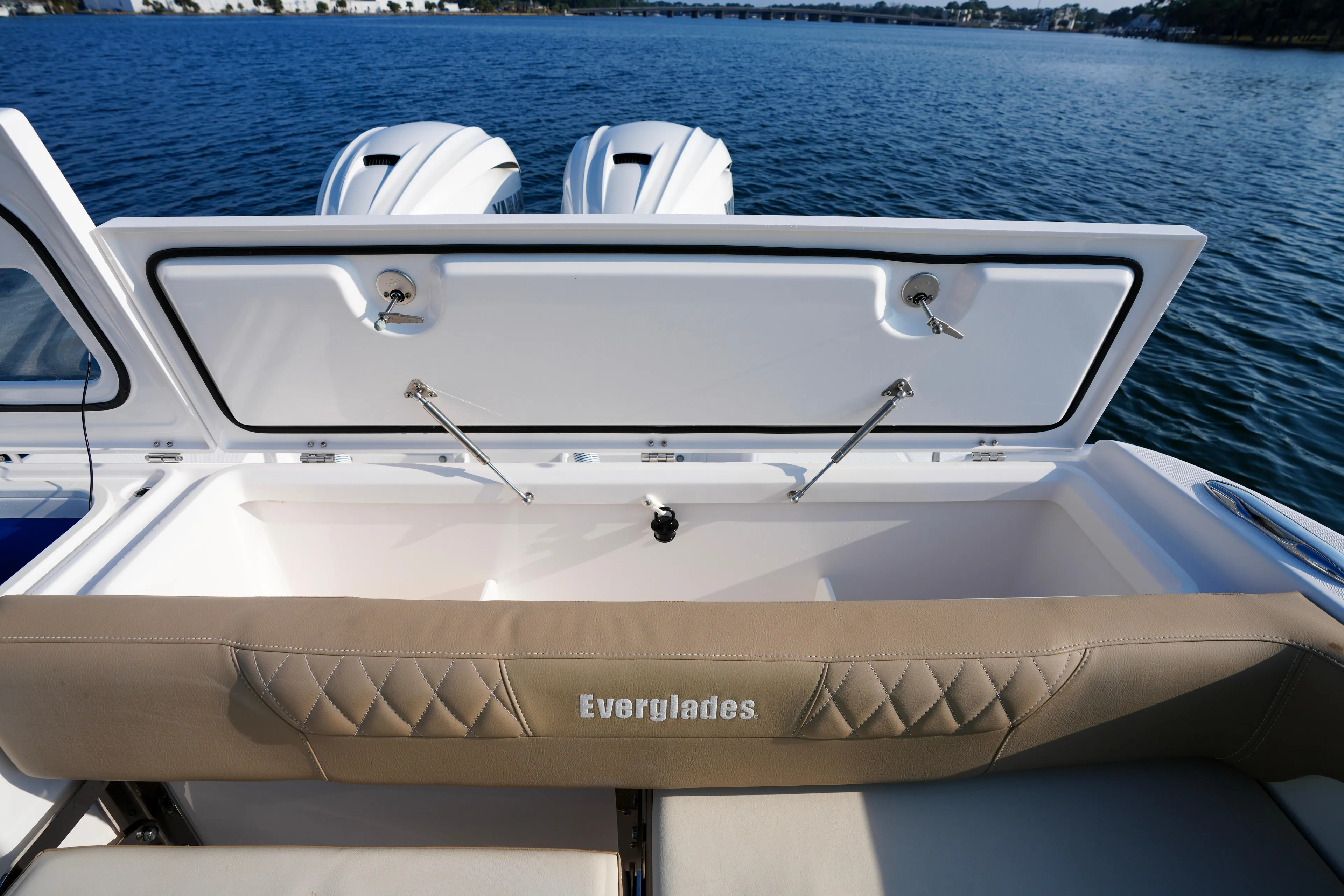  Yacht Photos Pics 2023 Everglades 340 Dual Console boat with open storage compartment, on calm water.