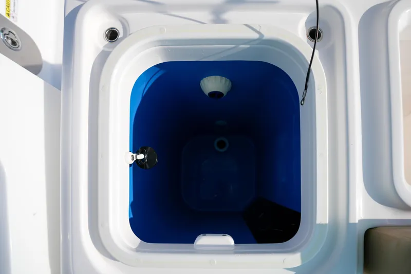  Yacht Photos Pics Livewell compartment on 2023 Everglades 340 Dual Console boat, featuring a blue interior.