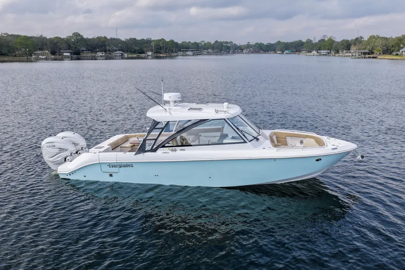  Yacht Photos Pics 2023 Everglades 340 Dual Console boat on calm water, showcasing sleek design and twin engines.