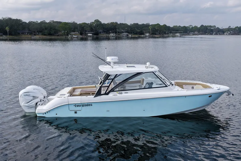  Yacht Photos Pics 2023 Everglades 340 Dual Console boat on calm water, showcasing sleek design and modern features.