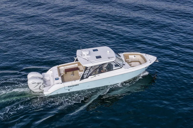  Yacht Photos Pics 2023 Everglades 340 Dual Console boat cruising on open water.