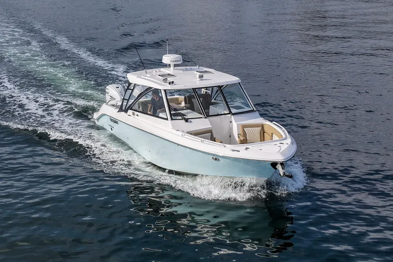  Yacht Photos Pics 2023 Everglades 340 Dual Console boat cruising on open water.