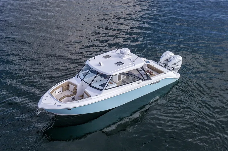  Yacht Photos Pics 2023 Everglades 340 Dual Console boat on calm water, featuring twin engines.
