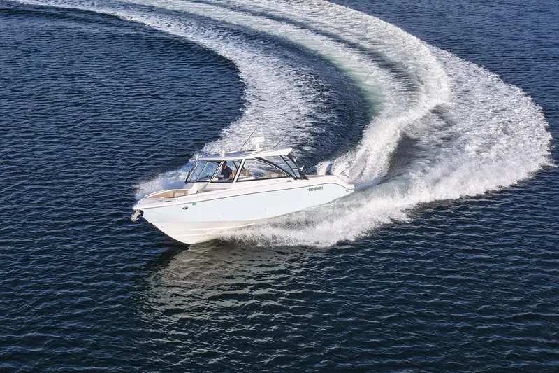  Yacht Photos Pics 2023 Everglades 340 Dual Console boat making a sharp turn on open water.
