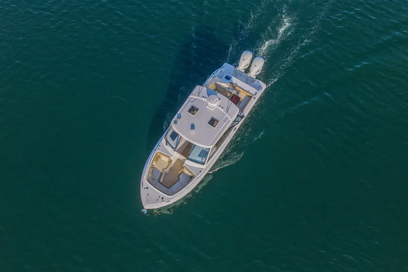  Yacht Photos Pics Aerial view of 2023 Everglades 340 Dual Console boat cruising on open water.