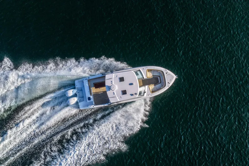  Yacht Photos Pics Aerial view of 2023 Everglades 340 Dual Console boat cruising on open water.