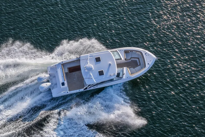  Yacht Photos Pics Aerial view of 2023 Everglades 340 Dual Console boat cruising on water.