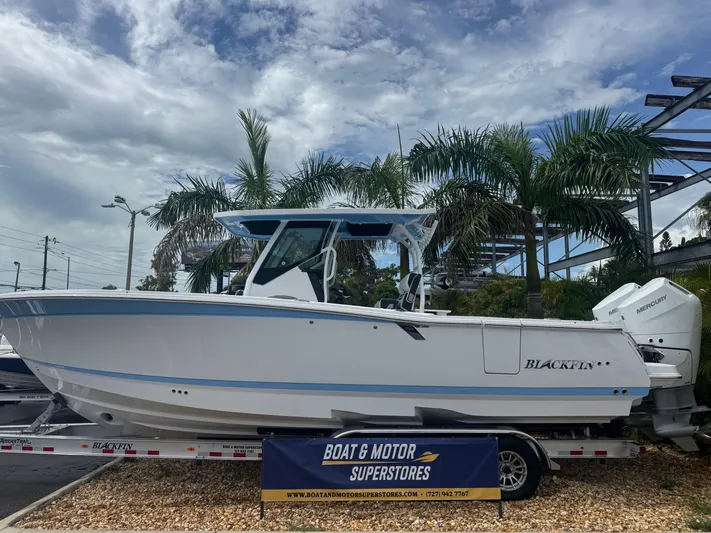  Yacht Photos Pics 2026 Blackfin 302 CC boat displayed at dealership, surrounded by palm trees.