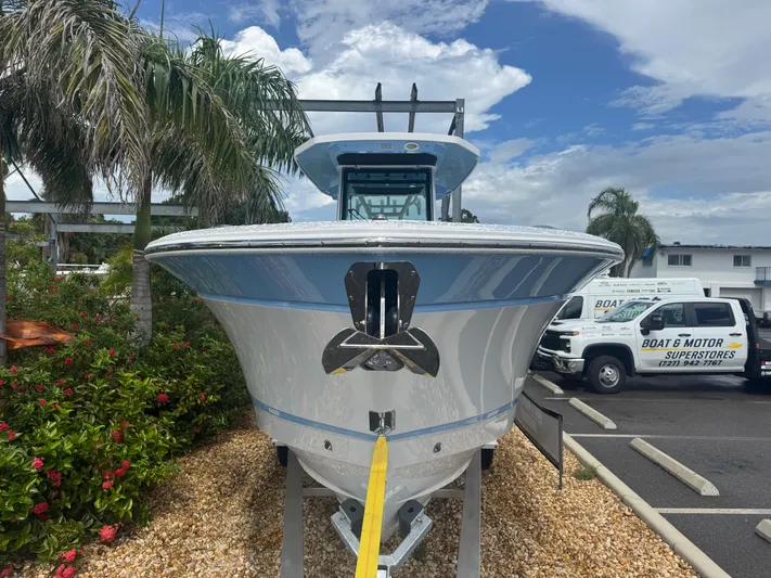  Yacht Photos Pics 2026 Blackfin 302 CC boat displayed outdoors with palm trees and vehicles in the background.