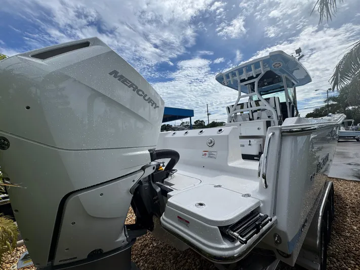  Yacht Photos Pics 2026 Blackfin 302 CC boat with Mercury engine under a cloudy sky.
