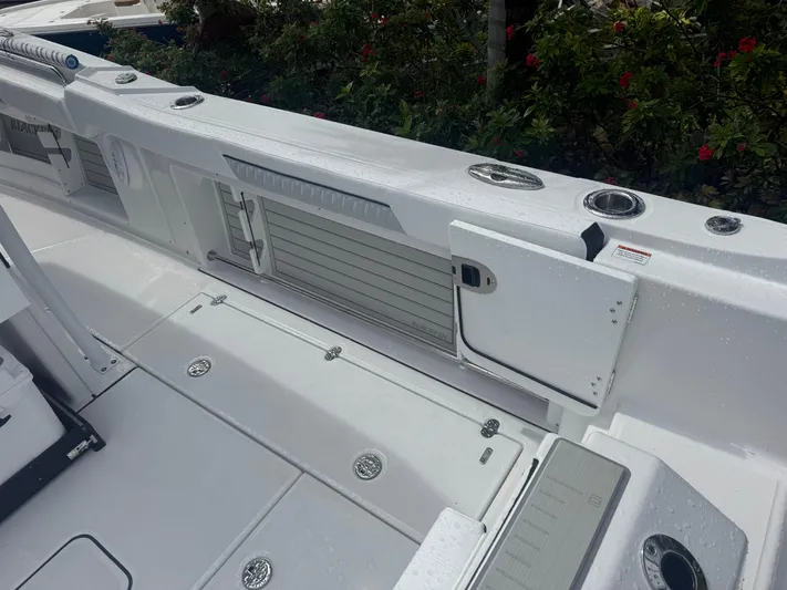  Yacht Photos Pics 2026 Blackfin 302 CC boat deck with storage compartments and rod holders.