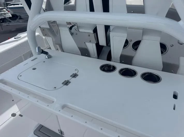  Yacht Photos Pics 2026 Blackfin 302 CC boat console with cup holders and storage compartment.