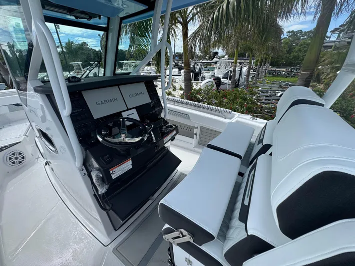  Yacht Photos Pics 2026 Blackfin 302 CC boat interior with Garmin displays and white seating.