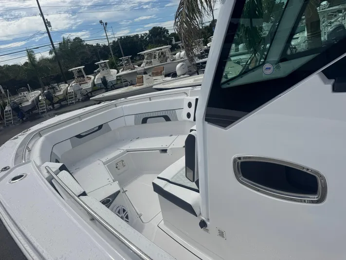  Yacht Photos Pics 2026 Blackfin 302 CC boat interior with seating, displayed outdoors.