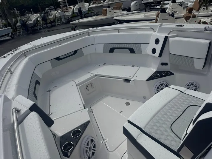  Yacht Photos Pics 2026 Blackfin 302 CC boat interior with seating, cup holders, and speakers.
