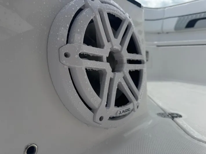  Yacht Photos Pics Close-up of JL Audio speaker on 2026 Blackfin 302 CC boat, with water droplets.