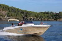 2023 Pacific Craft 750 Open boat cruising on a scenic lake with passengers.