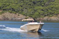 2023 Pacific Craft 750 Open boat cruising on a scenic lake with forested hills.