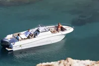 2023 Pacific Craft 750 Open boat cruising on clear blue water.
