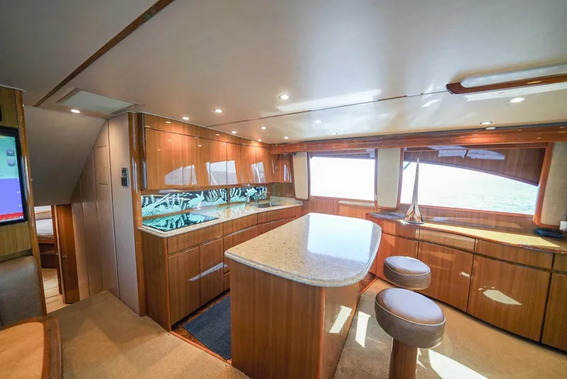 Synchronicity Yacht Photos Pics Luxurious interior of 2013 Viking 55 Convertible yacht with modern kitchen and seating area.