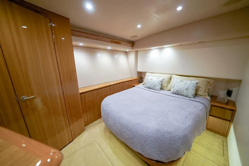 Synchronicity Yacht Photos Pics Luxurious bedroom in 2013 Viking 55 Convertible yacht with cozy bedding and wooden cabinetry.