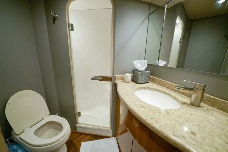 Synchronicity Yacht Photos Pics Luxurious bathroom in 2013 Viking 55 Convertible yacht with shower and granite countertop.