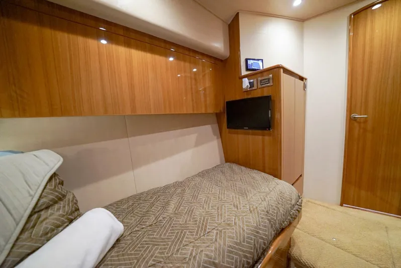 Synchronicity Yacht Photos Pics Luxurious cabin interior of 2013 Viking 55 Convertible yacht with wood paneling and cozy bedding.