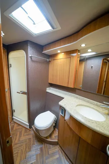 Synchronicity Yacht Photos Pics 2013 Viking 55 Convertible yacht bathroom with wood accents and modern fixtures.